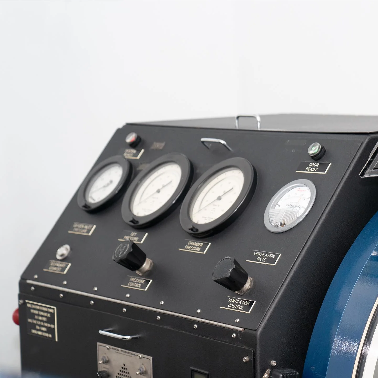 Close view of the Bella Oxygen hyperbaric chamber control panel with pressure gauges and valves